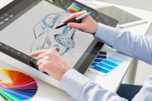 man drawing car on touch screen